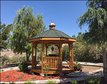 10 Cedar Octagon Belle Roof Gazebo shown with Red Cedar Deck, Rustic Evergreen Asphalt Shingles, 4 Bench sections, Cedar Tongue and Groove Ceiling, Cupola, and Clear Stain/Sealer.