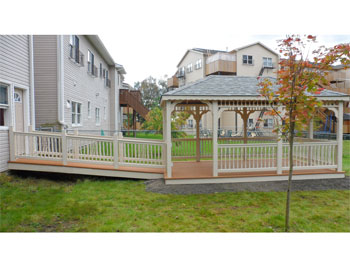 10 x 18 Ivory Vinyl Rectangle Gazebo shown with Virginia Slate Shingles, Cedar Composite Decking, 2x2 Decorative Spindle Rails, Extra Doorway Opening, Hidden Wiring w/ 1 Receptacle & Switch, and Custom Ramp with Railings