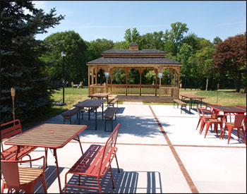 10 x 20 Cedar Rectangular Double Roof Gazebo shown with Cedar Deck, 2x3 Decorative Spindle Rails, Decorative Posts, Cupola, Customer Supplied Shingles, Custom Opening (Removed 2 Railings, 2 Top Railings, and 2 Posts) and Taller Posts.