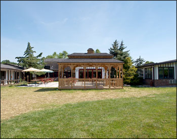 10 x 20 Cedar Rectangular Double Roof Gazebo shown with Cedar Deck, 2x3 Decorative Spindle Rails, Decorative Posts, Cupola, Customer Supplied Shingles, Custom Opening (Removed 2 Railings, 2 Top Railings, and 2 Posts) and Taller Posts.