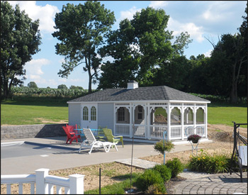 12 x 20 Vinyl Pool House shown in White Vinyl Siding with 30 Year Architectural Oxford Gray Asphalt Shingles, Gray Composite Deck, Shutters, Full Set of Screens, Cupola and Screened Door. 