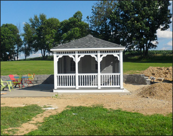 12 x 20 Vinyl Pool House shown in White Vinyl Siding with 30 Year Architectural Oxford Gray Asphalt Shingles, Gray Composite Deck, Shutters, Full Set of Screens, Cupola and Screened Door. 