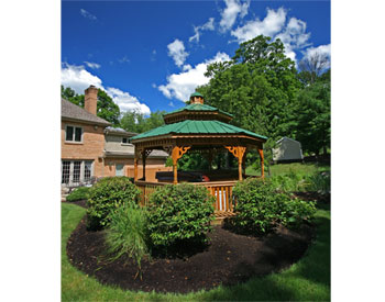 14 Treated Pine Double Roof Octagon Hot Tub Gazebo shown with Treated Pine Deck, 1x3 Railings, Decorative Posts, Decorative Braces, Cedar Stain Sealer, Stainless Steel Hardware, Sealed Base, and Evergreen Metal Roof.  Customer Installed Hot Tub. 