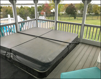 Detail Shot showing Solid Wall on back of Porch with Vinyl Siding on Both Sides, Finished Ceiling, Gray Composite Deck, Standard Railing, Screen with Screen Door, and 8x8 Floor Cutout for Customer Hot Tub.