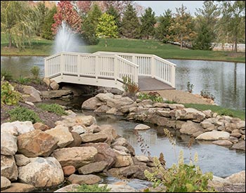  6 x 20 Straight Spindle Rail Bridge shown with Ivory Vinyl Railings, Madiera Trex Deck, Continuous Handrail, 36" High Rails, and Ivory Vinyl Beam Wrap.