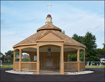 Custom 30 Treated Pine Oval Double Roof Gazebo shown with 42" Tall Railings with 3 Additional Openings, 10" Tall Posts, Arched Beams, Vinyl Finished Ceiling, Harvest Gold Asphalt Shingles, 8/12 Pitch Roof, 3 Full Wall Privacy Walls, Custom Portico, and Custom Fiberglass Cupola.