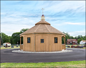 Custom 30 Treated Pine Oval Double Roof Gazebo shown with 42" Tall Railings with 3 Additional Openings, 10" Tall Posts, Arched Beams, Vinyl Finished Ceiling, Harvest Gold Asphalt Shingles, 8/12 Pitch Roof, 3 Full Wall Privacy Walls, Custom Portico, and Custom Fiberglass Cupola.